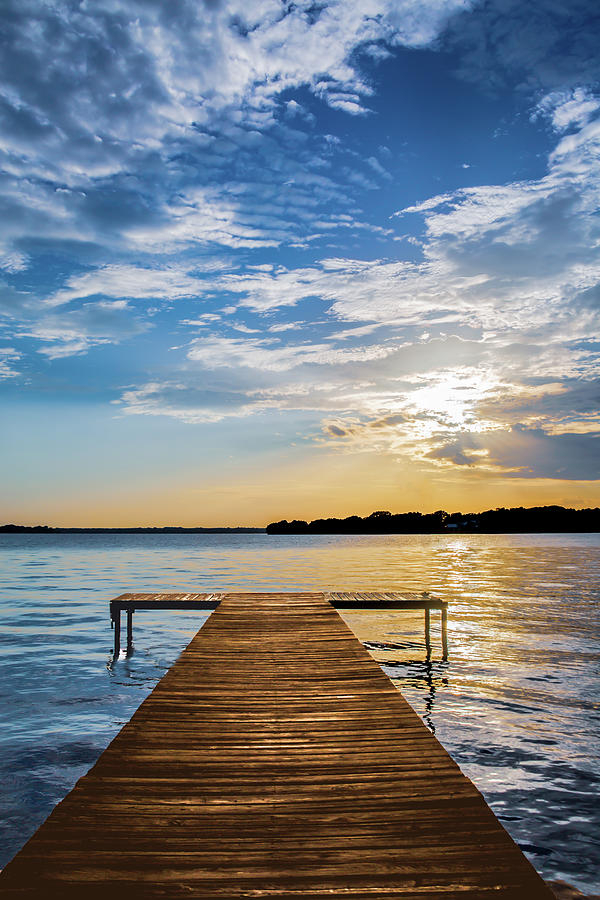 Unveiling the Tranquility of Boat Docked In Lake At Sunset