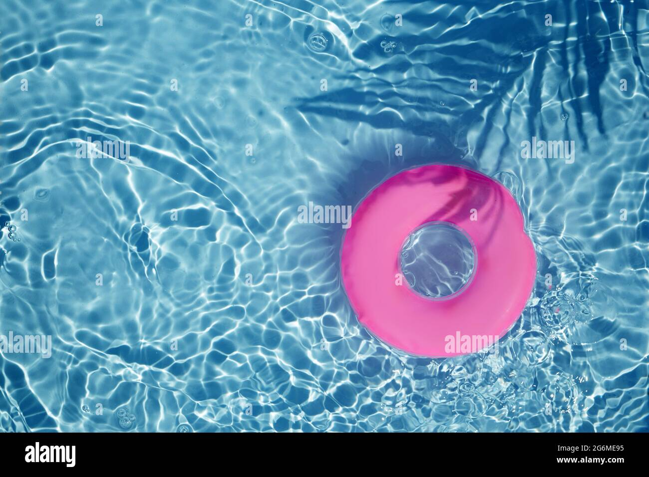 Pink Pool Float Ring Floating In A Refreshing Blue Swimming Pool. Top ... throughout Aerial View Pink Pool Floats, Plaque